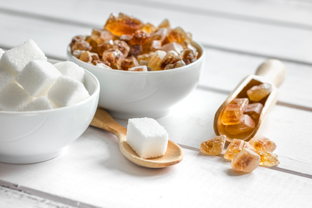 sugar cubes on white wooden table background close upの写真素材