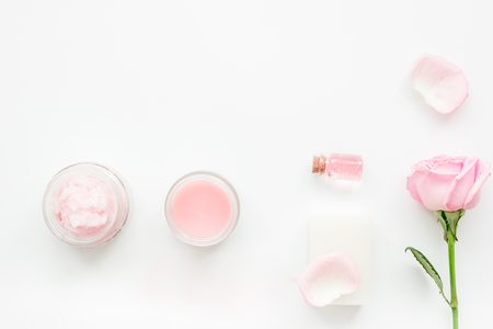 rose organic cosmetics with sea salt, cream and oil on white table background top viewの写真素材