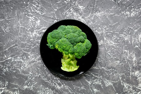 green fresh food for fitness diet on dark kitchen table background top view