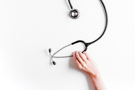 Medical equipment with stethoscope in doctor's office in hospital on white desk background top view mock-upの写真素材