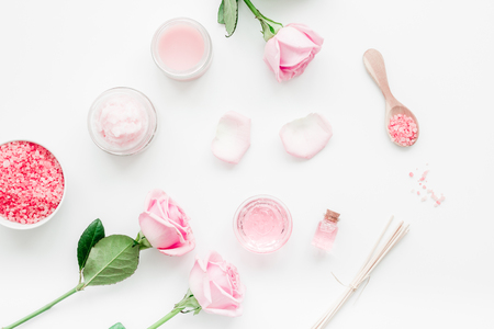 homemade spa with rose cosmetic set, cream, salt and oil on white desk background top viewの写真素材