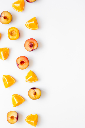 tropical fruits design with sliced orange and peach on white table background top view mock upの写真素材