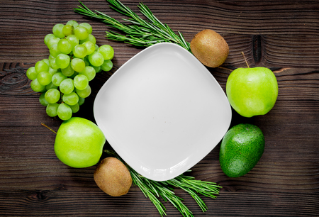 organic food for homemade salad with green vegetables on wooden desk background top view mock-upの写真素材