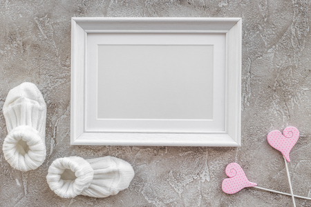 presents set for baby shower with frame on gray stone background top view mockupの写真素材