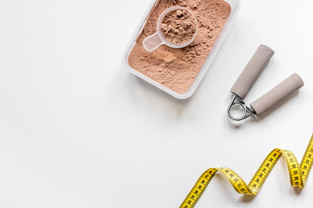 sport diet nutrition and fitness equipment , bars and measure tape on white background top view mock upの写真素材