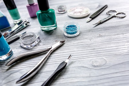 manicure and hands care set with nippers, cuticle scissors on light wooden table background mockupの写真素材