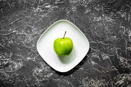 healthy food with green vegetables, fruits for dinner on dark table background top viewの写真素材