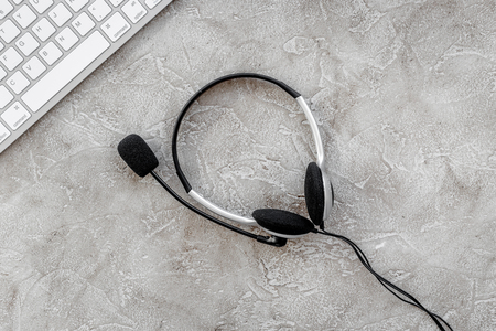 call center manager work with headset on stone desk background top viewの写真素材
