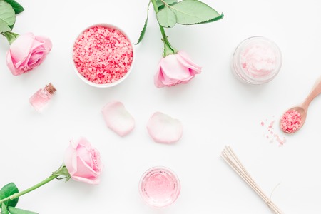 body treatment with rose flowers and cosmetic set on white desk background top viewの写真素材