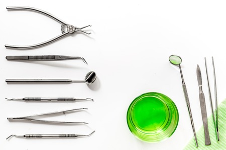 dentist tools for teeth care close up on white hospital desk background top view mockupの写真素材