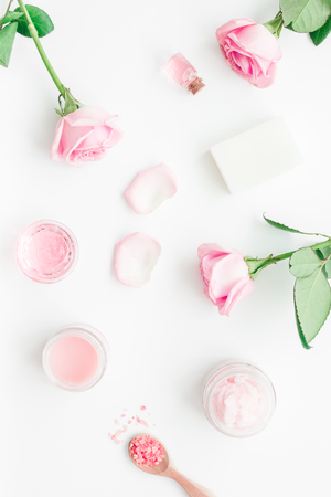 spa set with rose flowers and cosmetic for body care on white desk background top viewの写真素材