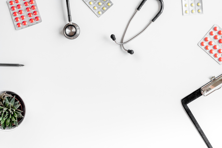 doctors work with stethoscope and pills on hospital desk background top view mock upの写真素材