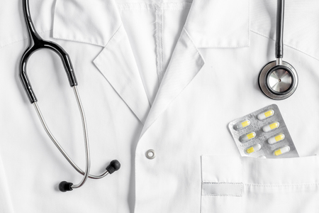doctors work desk in hospital with stethoscope overall background top viewの写真素材