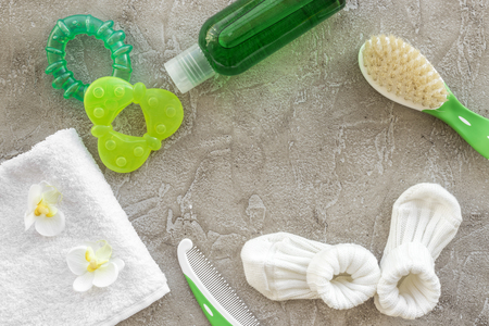 bath cosmetic set for kids, towel and hair brush on gray stone background top view space for textの写真素材