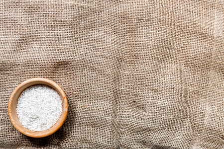 rice in plate with napkin for tasty paella on brown faric background top view mock-upの写真素材