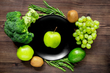 healthy food with green vegetables, fruits for dinner on rustic table background top viewの写真素材