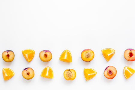 tropical fruits design with sliced orange and peach on white table background top view mock upの写真素材