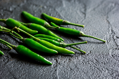 hot food with green chili pepper on dark table background close upの写真素材