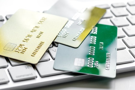 business with credit cards for payment on keyboard on office desk white background close upの写真素材