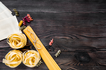 Assortment of different shape italian pastas on grey wooden table top view copyspaseの写真素材