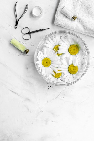 Spa composition on white desk with chamomile, towel and manicure set copyspase top view.の写真素材