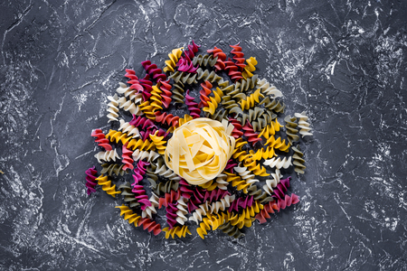 Italian food concept various kind of pasta on grey stone table top view copyspace.の写真素材