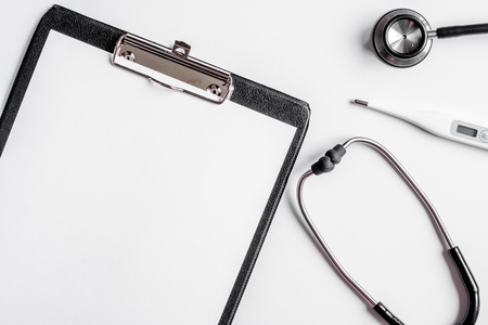 doctor's work place with stethoscope and copybook on hospital desk background top view mock upの写真素材