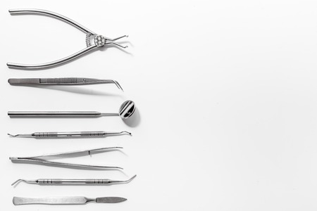 teeth care with dentist instruments in doctor's office on white background top view mock-up