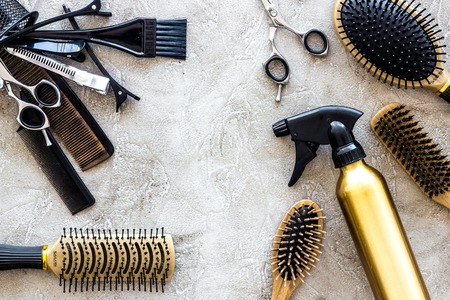Combs and hairdress tools on stone table background top view.の写真素材