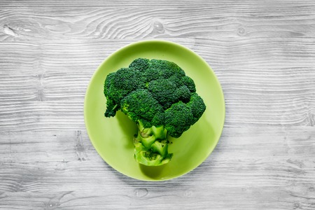 healthy food with green vegetables, fruits for fitness dinner on gray table background top viewの写真素材