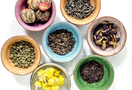 Tea-party with different herbal tea on white kitchen desk background flat lay patternの写真素材