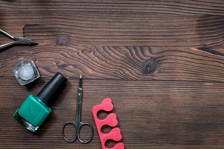 nail artist desk with manicure set and nail polish for hands care wooden background top view mockupの写真素材