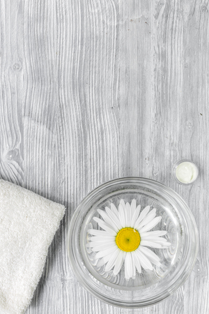 Spa composition on wooden desk with chamomile and towel copyspase top view verticalの写真素材