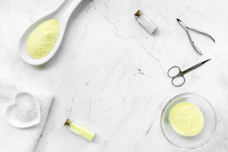natural cosmetics with bowl of chamomiles and tools for manicure on white textural background top view space for textの写真素材