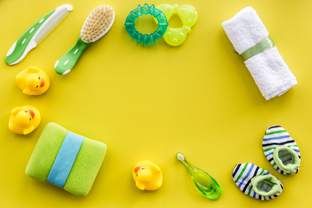 baby accessories for bath with body cosmetic and ducks on yellow background top view mock-upの写真素材