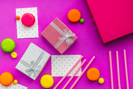 Birthday greeting cards and wrapped gifts on fuchsia background top view.の写真素材