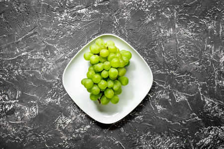 healthy food with green vegetables, fruits for fitness dinner on dark table background top viewの写真素材