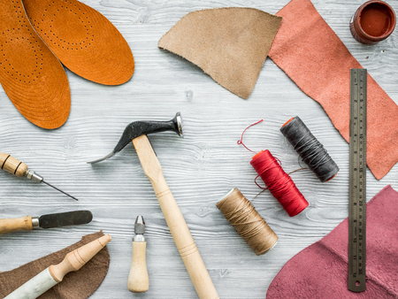 Work desk of clobber. Skin and tools on grey wooden desk background top view