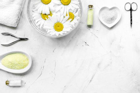 Spa composition on white desk with salt, chamomile, towel and manicure set copyspase top viewの写真素材