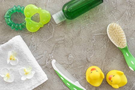 Baby care accessories, toys, towel and clothing on gray background top view mock upの写真素材