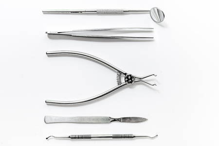 teeth care with dentist instruments in doctors office white background top viewの写真素材