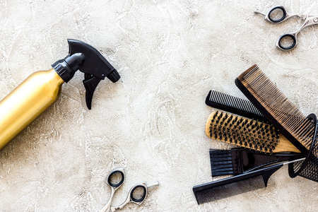 Professional hairdressing tools and accessories on stone table background top view copyspaceの写真素材