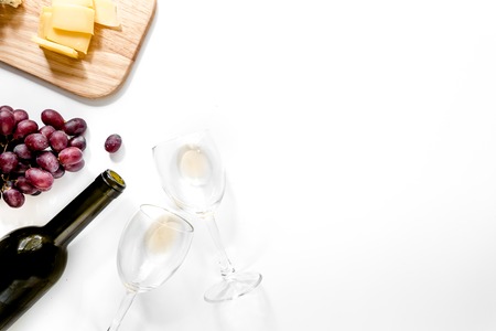 Set for drinking wine with cheese and red grape on white background copyspace top viewの写真素材