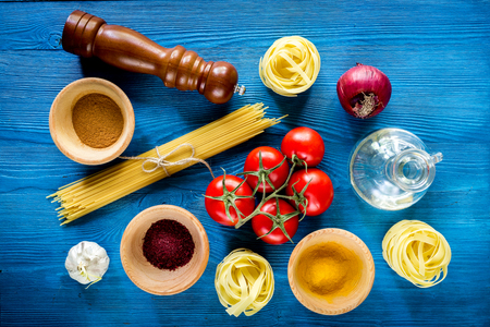 Food ingredients for Italian pasta on blue wooden desk background top viewの写真素材