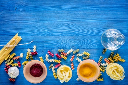 Food ingredients for Italian pasta on blue wooden desk background top view copyspaceの写真素材