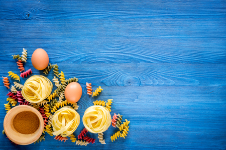 Food ingredients for Italian pasta on blue wooden desk background top view copyspaceの写真素材