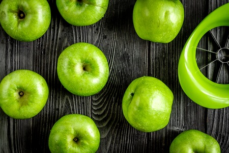green apples close up pattern dark wooden desk background top viewの写真素材