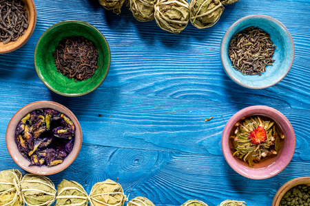 Tea-party with different herbal tea on blue kitchen desk background flat lay mock upの写真素材