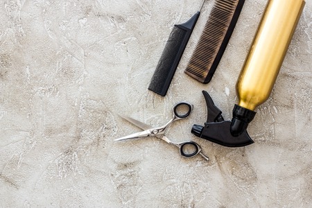Professional hairdressing tools and accessories on stone table background top view copyspaceの写真素材