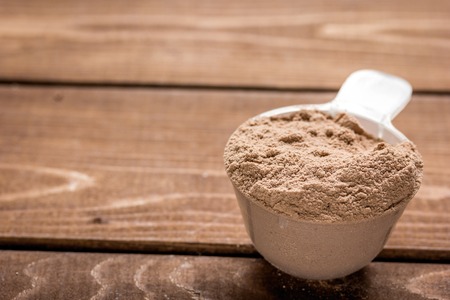 Fitness nutrition with scoop on wooden backgroundの写真素材